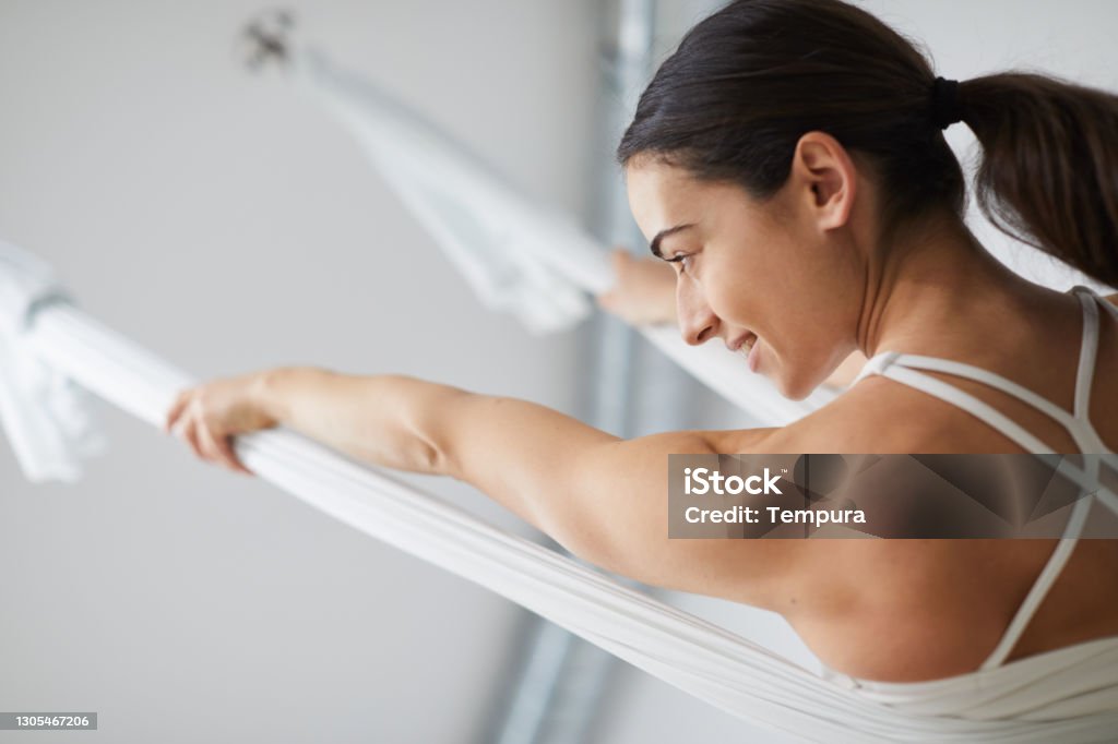 One woman practicing flying yoga. Yoga Pilates and barre studio
Barcelona. Italian yoga instructor. Aerial Yoga Stock Photo
