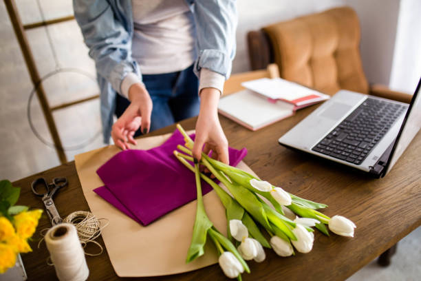 istock Young woman arranging a bouquet 1305467209