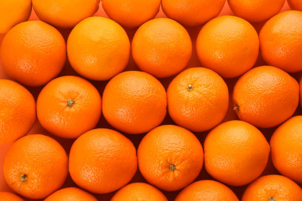 istock Fresh ripe oranges as background, top view 1305467555