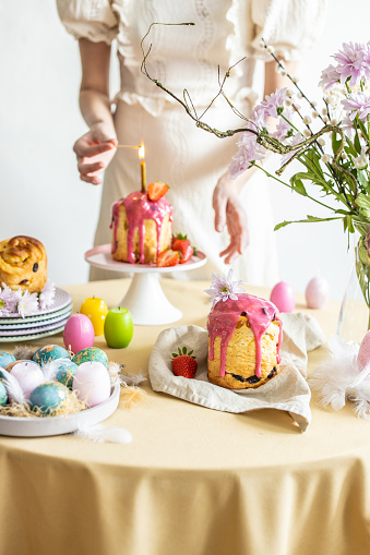 Easter table setting. Easter cake craffin. Woman on background