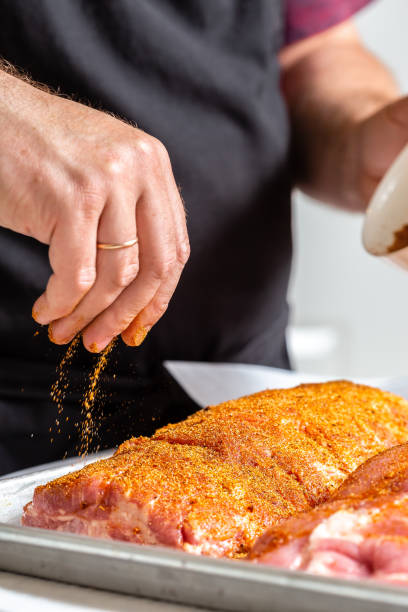 istock Chef puts spices on the raw piece of meat 1305469127