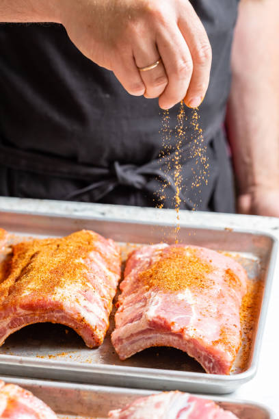 istock Chef puts spices on the raw piece of meat 1305469143