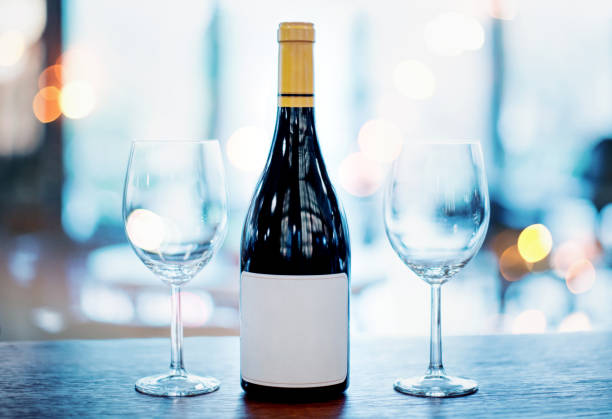 istock Wine bottle and two empty wineglasses on a bar counter, ready to be served. 1305469209