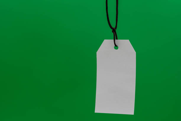 istock Multiple blank white tag price hanging on green background 1305473807