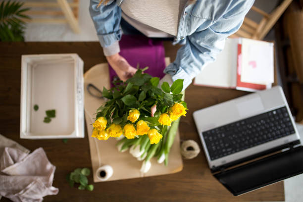 istock Top view of a woman making a bouquet 1305475806