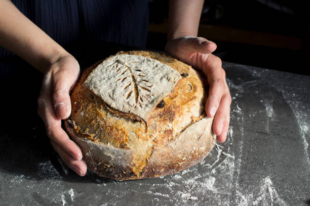 istock Beautifully decorated bread in woman's hands 1305477013