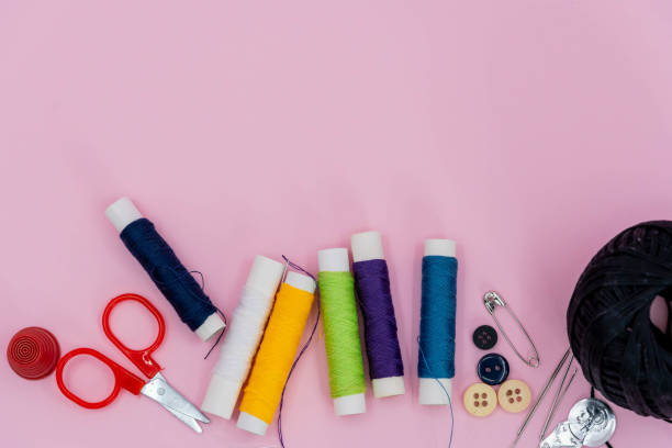 istock Sewing kit accessories.set tools for tailoring and colorful threads,needles,pins,scissors on green background mockup frame top view. 1305477153