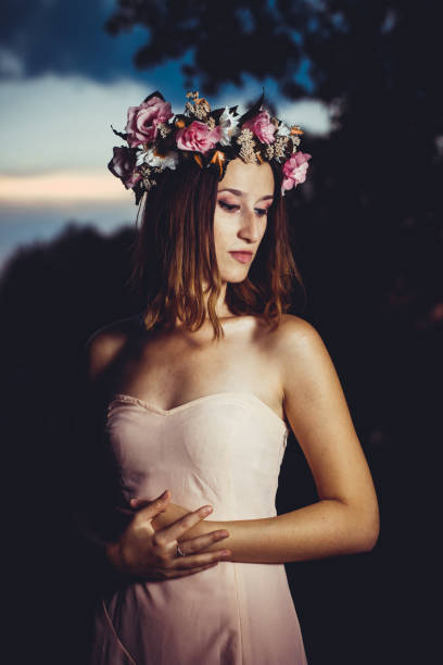 istock Beautiful woman with floral wreath 1305477295