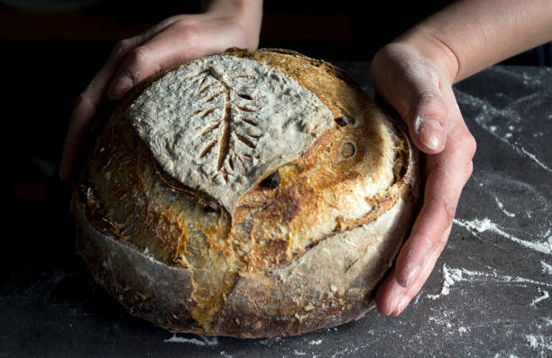 istock Beautifully decorated bread in woman's hands 1305477321