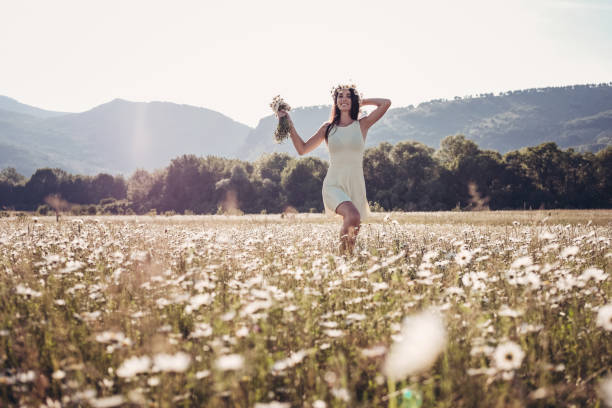 istock Beautiful young girl smiling over chamomile field. 1305477842