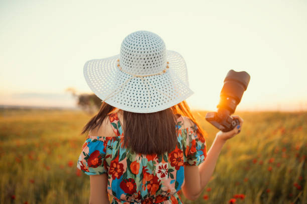 Photographer woman sunset back view