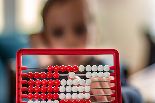 Small fingers on the red abacus