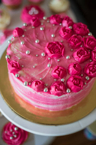 istock Beautiful pink cake with decorations on table. 1305483471