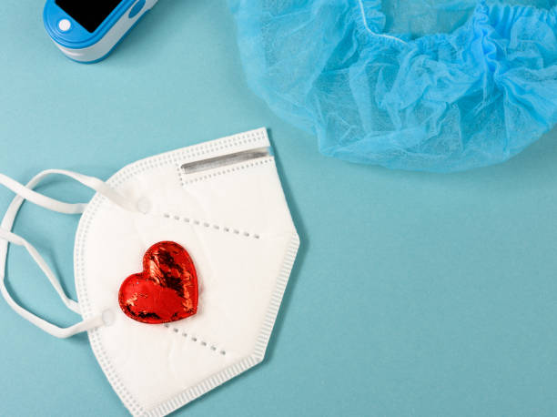 istock disposable white medical mask, oximeter on blue background 1305485109