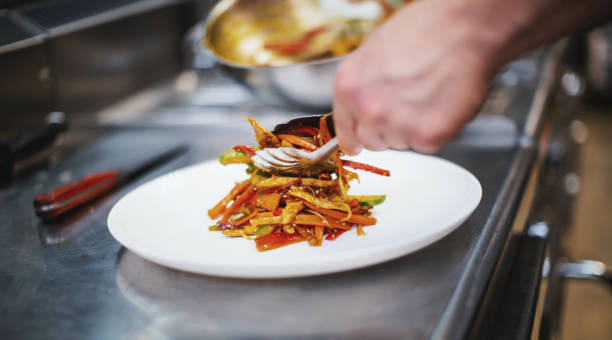 istock Arranging delicious meal in the restaurant kitchen. 1305487972