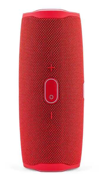 Photo of Red Portable Wireless Speaker Isolated on White Background. Mobile Loudspeaker Red Color with Ribbed Texture and Push Control Buttons. Vertical Position. Close-up.