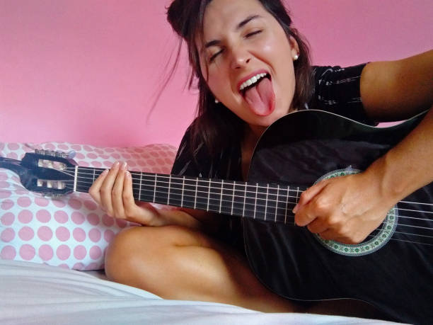 istock Girl playing rock and roll songs 1305490425