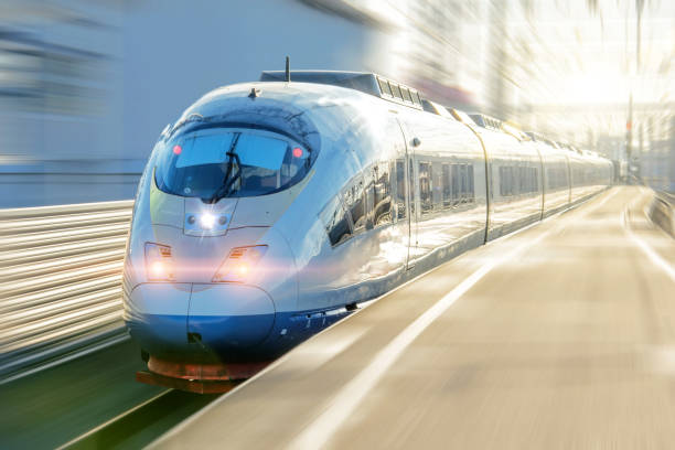 electric passenger train drives at high speed departs from the platform. - transportation railroad track train railroad car imagens e fotografias de stock