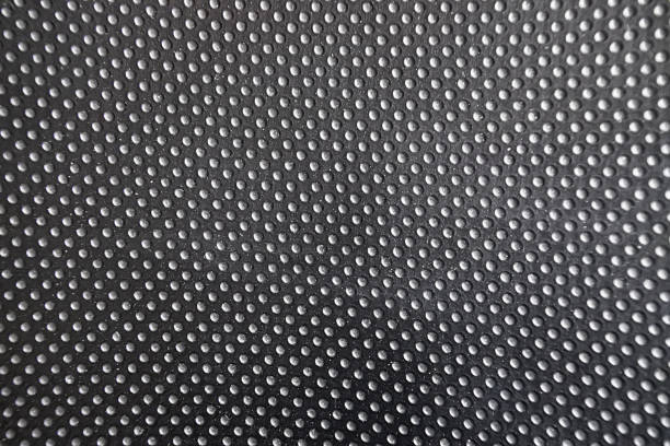 istock Black polka dotted background with small white dots 1305490686