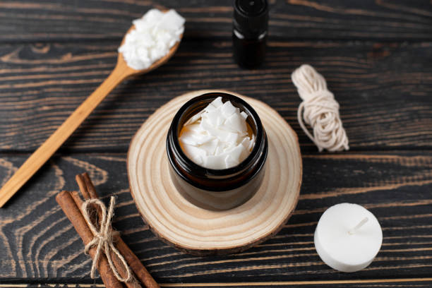 istock Basic set for home-made natural white eco soy wax candles in glass, wick, perfume. Idea for a hobby, business. Making trendy diy candles without harm to health on wood background. 1305492201
