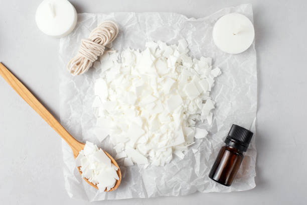 istock Basic set for home-made natural white eco-friendly soy wax candles, wick, perfume. Idea for a hobby, business. Making trendy diy candles without harm to health on white background, top view 1305492222