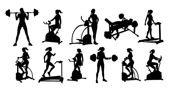A woman in silhouette using pieces of gym fitness equipment and machines set