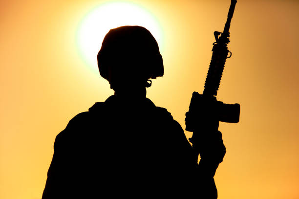 istock Marines shooter silhouette on background of sunset 1305492472