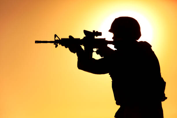 istock Soldier shooting with service rifle on sunset 1305492489