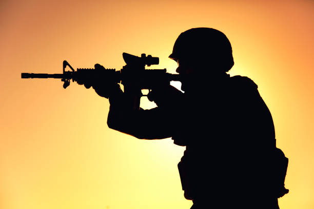 istock Soldier shooting with service rifle on sunset 1305492492