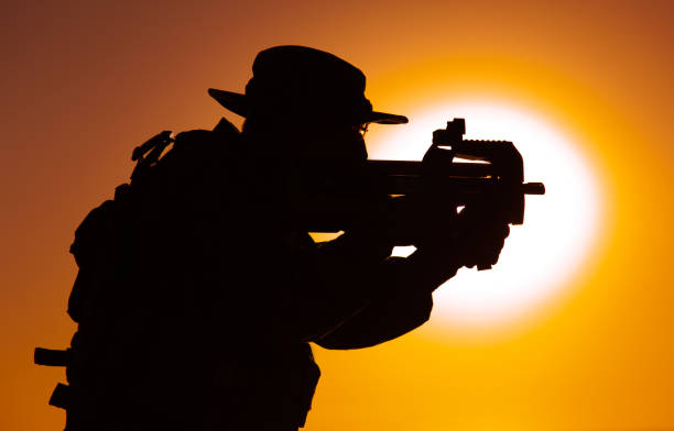 istock Army soldier shooting with bullpup submachine gun 1305492540