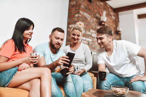 istock Cute Couples Looking At Social Media On Smartphone While Enjoying Coffee 1305493279