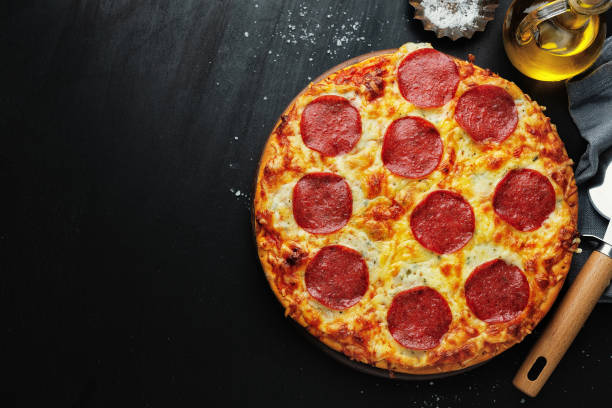 istock Pizza with salami and cheese on pizza box 1305496132