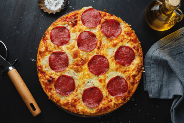 istock Pizza with salami and cheese on pizza box 1305497778
