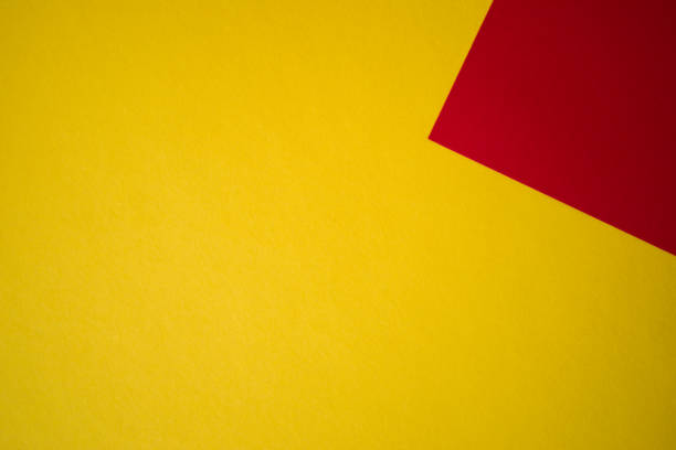 istock Yellow and red colored paper background 1305500229