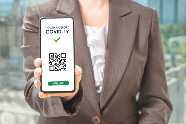 covid-19 health pass app concept on smart phone. woman hodling phone. qr code for verification of immunization after vaccination with covid vaccine - mundial 2022 imagens e fotografias de stock