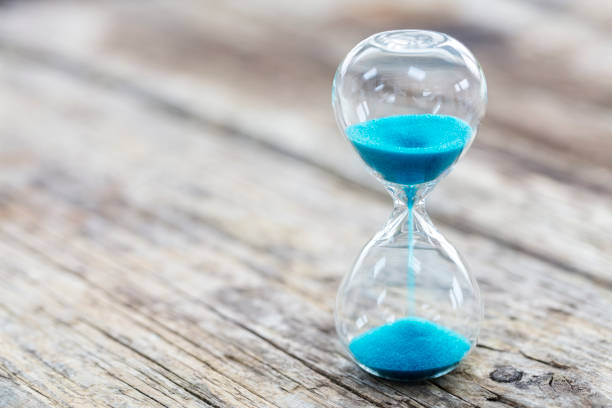 istock Blue hourglass background concept for deadline, urgency and countdown 1305501374