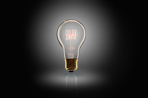 Idea concept -  incandescent light bulb on the black background