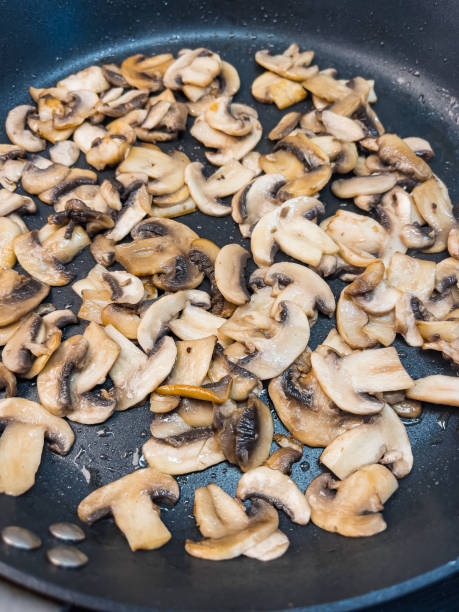 istock Fried mushrooms in pan 1305505612