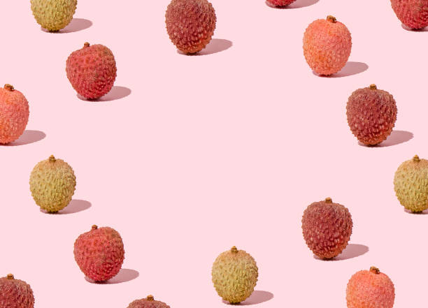 istock Creative pattern with copy space made with fresh colorful lychees against on pink background. Minimal spring and summer fruit layout. 1305507299