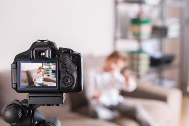 istock Vlogger recording social media video while sitting on the couch 1305507645