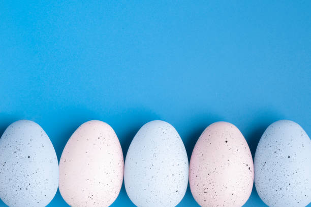 istock Colorful eggs on blue easter background with copy space, place for text 1305509127