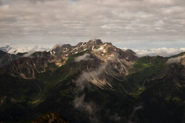 istock Hiking through the alps on a beautiful cloudy summer day. 1305509263