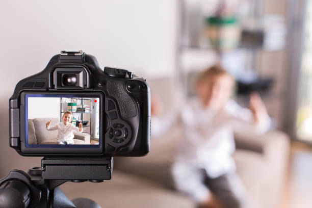 istock Vlogger recording social media video while sitting on the couch 1305509277