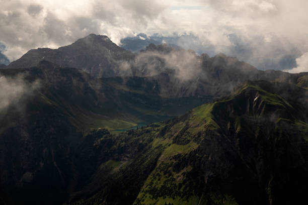 istock Hiking through the alps on a beautiful cloudy summer day. 1305509828