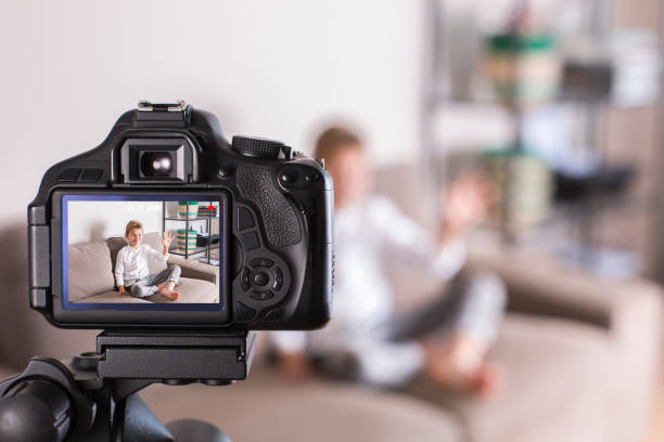 istock Vlogger recording social media video while sitting on the couch 1305509874