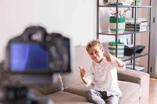 istock Vlogger recording social media video while sitting on the couch 1305510046