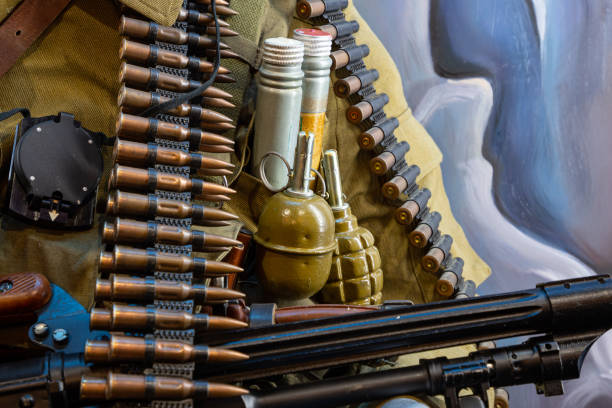 istock Machine-gun tapes on ammunition background 1305511175