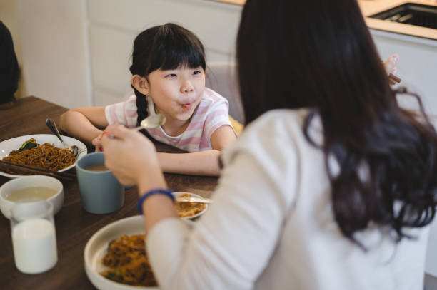 istock An Asian family having breakfast at home 1305511336