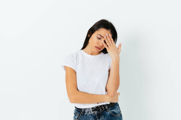 istock Woman suffering from headache touching her forehead 1305512777