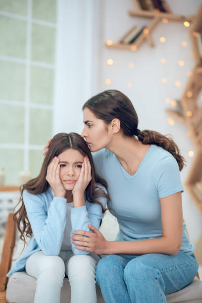 istock Upset daughter and caring mom sitting at home 1305514119